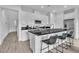 Modern kitchen features white cabinets, stainless steel appliances, and a black countertop island with seating at 2699 Chance Canyon St, Henderson, NV 89044