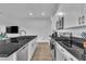 Well-equipped kitchen with stainless steel appliances, black countertops, ample cabinet space, and a modern design at 2699 Chance Canyon St, Henderson, NV 89044