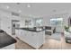 Open floor plan showing kitchen with modern appliances and island flowing into the living room area at 2699 Chance Canyon St, Henderson, NV 89044