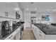 Modern kitchen with white cabinets, stainless steel appliances, and a black countertop island at 2699 Chance Canyon St, Henderson, NV 89044