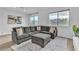 Bright living room featuring a comfortable gray sectional sofa, patterned rug, and ample natural light at 2699 Chance Canyon St, Henderson, NV 89044