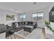 Living room with a comfortable gray sectional sofa, patterned rug, and natural light at 2699 Chance Canyon St, Henderson, NV 89044
