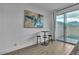 Bright living space with modern decor, stylish bar table, and sliding glass doors leading to the backyard at 2699 Chance Canyon St, Henderson, NV 89044