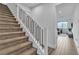 Carpeted staircase with black metal railing and view of the living room at 2699 Chance Canyon St, Henderson, NV 89044