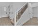Modern staircase featuring a black metal railing and wood-look tile floors at 2699 Chance Canyon St, Henderson, NV 89044