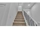 Clean staircase with carpeted steps, white walls, and modern railings leading to the upper level of the home at 2699 Chance Canyon St, Henderson, NV 89044