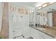 Bright bathroom with a granite vanity, decorative mirrors, and a tiled shower area at 3111 Bel Air Dr # 20D, Las Vegas, NV 89109
