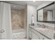 Clean bathroom featuring a shower-tub combo with tiled walls and a granite vanity top at 3111 Bel Air Dr # 20D, Las Vegas, NV 89109