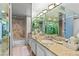 Bathroom with mirrored cabinets, granite countertop, and walk in shower at 3111 Bel Air Dr # 20D, Las Vegas, NV 89109