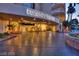 Regency Towers building entrance featuring palm trees, covered entrance, and ample parking space at 3111 Bel Air Dr # 20D, Las Vegas, NV 89109