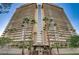 Exterior of Regency Towers featuring a high-rise condo with balconies and palm trees at 3111 Bel Air Dr # 20D, Las Vegas, NV 89109