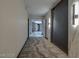 Well-lit hallway with patterned carpet, decorative lighting, and access to rooms at 3111 Bel Air Dr # 20D, Las Vegas, NV 89109