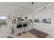 Modern kitchen featuring white cabinetry, stainless steel appliances, granite countertops, and bar stool seating at 3111 Bel Air Dr # 20D, Las Vegas, NV 89109