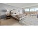 Cozy main bedroom featuring a tufted headboard, plush bedding and a picturesque view from the window at 3111 Bel Air Dr # 20D, Las Vegas, NV 89109