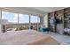 Bright bedroom featuring an accent chair, built-in shelving, and expansive windows with stunning city views at 3111 Bel Air Dr # 20D, Las Vegas, NV 89109