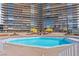 Large outdoor community swimming pool area with lounge seating and sun shades for residents at 3111 Bel Air Dr # 20D, Las Vegas, NV 89109