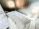 Close-up of a modern bathtub with hydrotherapy jets, and marble surround tile, perfect for relaxation at 4381 W Flamingo Rd # 2109, Las Vegas, NV 89103