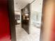 View of a hallway with a glimpse of a hotel suite, leading to a modern, marble-tiled bathroom at 4381 W Flamingo Rd # 2109, Las Vegas, NV 89103