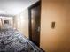 Well-lit hallway leading to unit 309, featuring stylish carpet and modern fixtures at 4381 W Flamingo Rd # 2109, Las Vegas, NV 89103