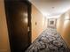 Elegant hallway with patterned carpet and warm lighting, providing a welcoming entrance to the suites at 4381 W Flamingo Rd # 2109, Las Vegas, NV 89103