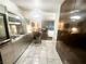 Modern stainless steel kitchenette with marble flooring and bar top dining at 4381 W Flamingo Rd # 2109, Las Vegas, NV 89103