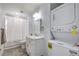 Functional bathroom featuring a vanity, toilet, shower, and a stackable washer/dryer at 500 Duchess Ave, North Las Vegas, NV 89030