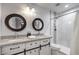 Updated bathroom features dual sinks, granite counters, and a tiled shower at 500 Duchess Ave, North Las Vegas, NV 89030