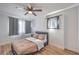 Cozy bedroom featuring wood-look floors, modern ceiling fan, and relaxing natural light at 500 Duchess Ave, North Las Vegas, NV 89030