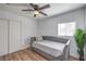Bright bedroom featuring wood-look floors, ceiling fan, and a cozy daybed next to a sunny window at 500 Duchess Ave, North Las Vegas, NV 89030