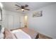Bright bedroom with ceiling fan, wood-look floors, storage and artwork above a queen bed at 500 Duchess Ave, North Las Vegas, NV 89030