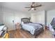 Cozy bedroom with wood-look floors, a comfortable bed, and a ceiling fan at 500 Duchess Ave, North Las Vegas, NV 89030
