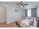 Bedroom with wood-look floors, ceiling fan, natural light and art hanging over the bed at 500 Duchess Ave, North Las Vegas, NV 89030