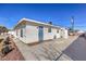 Exterior view of a stucco home with a spacious driveway and well-maintained landscaping at 500 Duchess Ave, North Las Vegas, NV 89030