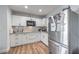 Well-lit kitchen featuring white cabinetry, granite countertops, and stainless steel appliances at 500 Duchess Ave, North Las Vegas, NV 89030