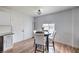 Kitchen nook features wood floors, a black table with white chairs and a window with blinds at 500 Duchess Ave, North Las Vegas, NV 89030