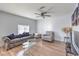 Spacious living room with wood-look floors, ceiling fan, and comfortable seating at 500 Duchess Ave, North Las Vegas, NV 89030