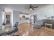 Open-concept living space with modern furnishings, wood flooring, and a bright kitchen view at 500 Duchess Ave, North Las Vegas, NV 89030