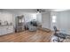 Spacious living area with wood floors, a modern chair, and an adjacent kitchen at 500 Duchess Ave, North Las Vegas, NV 89030