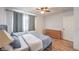 Bright main bedroom features wood-look floors, curtains and light from the window at 500 Duchess Ave, North Las Vegas, NV 89030