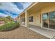 Covered back patio with desert landscaping and manicured bushes at 538 Cypress Gardens Pl, Henderson, NV 89012
