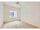 A bright, empty bedroom features neutral carpeting and a ceiling fan at 538 Cypress Gardens Pl, Henderson, NV 89012