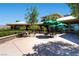 Outdoor patio area with tables and umbrellas outside the community clubhouse at 538 Cypress Gardens Pl, Henderson, NV 89012