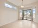 Bright dining room boasts tile flooring and access to the backyard through a sliding glass door at 538 Cypress Gardens Pl, Henderson, NV 89012