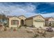 Charming single-story home with a well-manicured desert landscape, arched entry, and a two-car garage at 538 Cypress Gardens Pl, Henderson, NV 89012