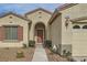 Close-up of the home's entry, showcasing the arched doorway, desert landscaping, and address number at 538 Cypress Gardens Pl, Henderson, NV 89012