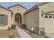 Detailed view of the home's front entrance with desert landscaping, an arched doorway, and updated hardware at 538 Cypress Gardens Pl, Henderson, NV 89012