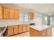 Bright kitchen features an island, tile floors, light wood cabinets, and white appliances at 538 Cypress Gardens Pl, Henderson, NV 89012