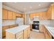 Functional kitchen featuring wooden cabinetry, white countertops, tile flooring, and modern appliances at 538 Cypress Gardens Pl, Henderson, NV 89012