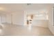 Open-concept living room with neutral paint, tile flooring, and seamless flow into the kitchen at 538 Cypress Gardens Pl, Henderson, NV 89012