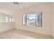 Bright main bedroom features neutral tones, tile flooring, a ceiling fan, and a large window at 538 Cypress Gardens Pl, Henderson, NV 89012